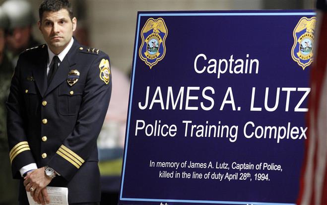 Waukesha Deputy Chief Dennis Angle reveals a sign during the renaming of the department’s training complex after Capt. James A. Lutz.