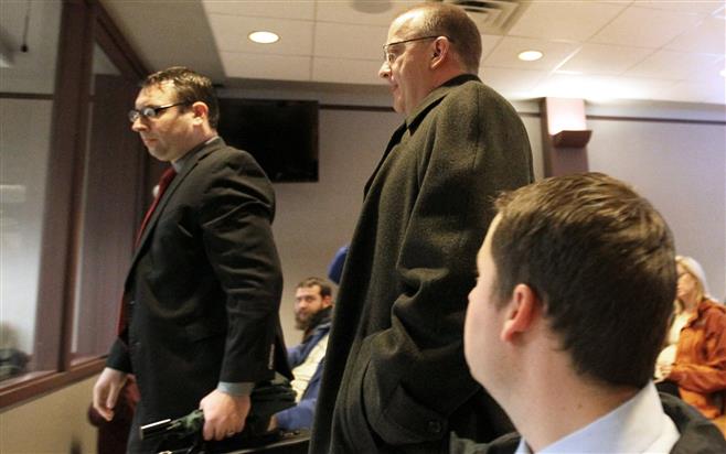 Rep. Bill Kramer (center) on Thursday enters a Waukesha County Circuit courtroom, where he waived his right to a preliminary hearing on two felony charges of second degree sexual assault.